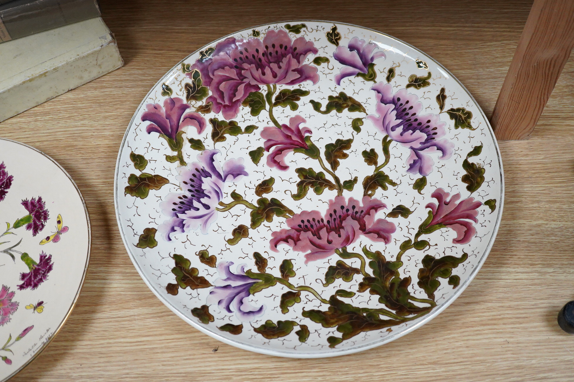 A Zsolnay-type floral charger, 39cm diameter and similar smaller Schutz Cilli plate